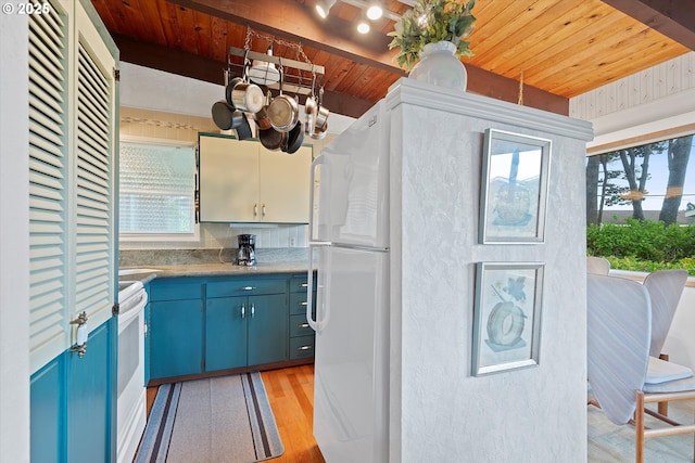 320 El Rotundo Ave, Lincoln City, OR 97367 - kitchen featuring blue cabinetry, wooden ceiling, light wood finished floors, white appliances, and a chandelier