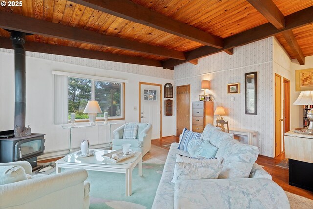 320 El Rotundo Ave, Lincoln City, OR 97367 - living area with a wood stove, wood finished floors, wood ceiling with exposed beams, and wallpapered walls