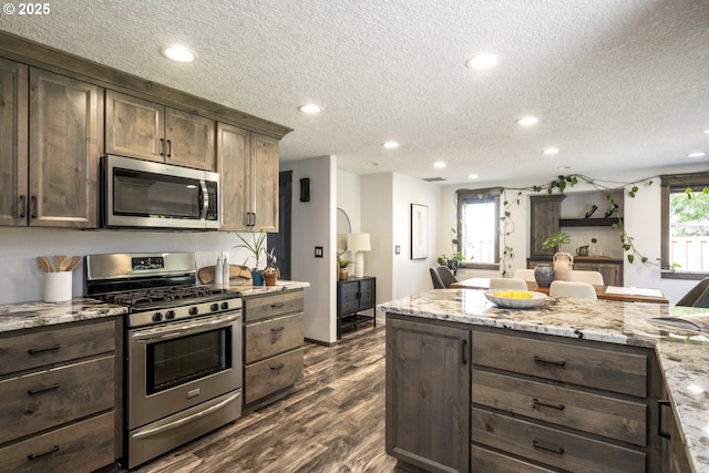2005 SW Stella Way, Troutdale, OR 97060 - kitchen featuring stainless steel appliances, recessed lighting, a textured ceiling, dark wood-type flooring, and dark brown cabinets