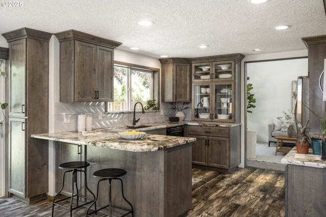 2005 SW Stella Way, Troutdale, OR 97060 - kitchen with a peninsula, light stone counters, dark wood-style flooring, decorative backsplash, and a textured ceiling