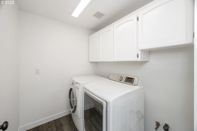 2005 SW Stella Way, Troutdale, OR 97060 - laundry area featuring cabinet space, washer and dryer, dark wood-style flooring, and baseboards
