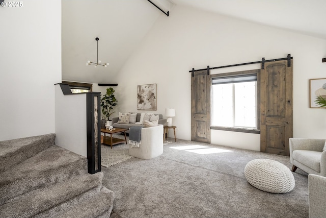 2005 SW Stella Way, Troutdale, OR 97060 - carpeted living room with beam ceiling, a barn door, high vaulted ceiling, a chandelier, and stairs
