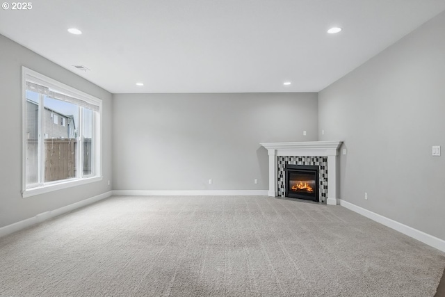 7698 NW Catalpa St, Portland, OR 97229 - unfurnished living room featuring baseboards, a tiled fireplace, light colored carpet, and recessed lighting