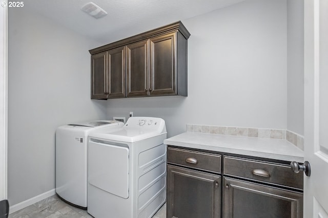 7698 NW Catalpa St, Portland, OR 97229 - laundry room with cabinet space, independent washer and dryer, light marble finish floors, and baseboards