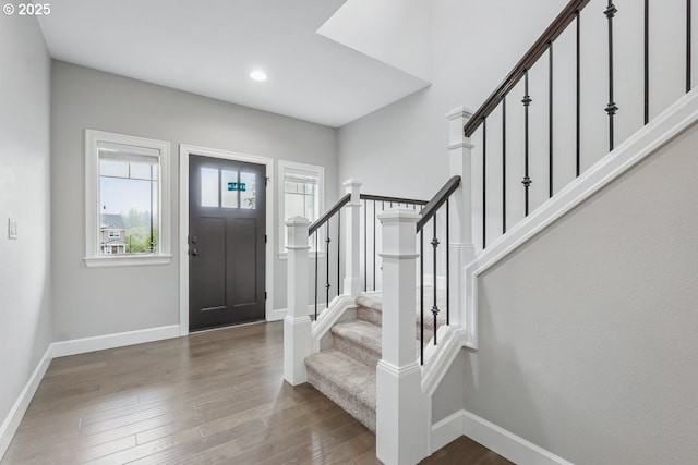 7698 NW Catalpa St, Portland, OR 97229 - foyer entrance featuring stairway, wood finished floors, baseboards, and recessed lighting