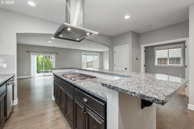 7698 NW Catalpa St, Portland, OR 97229 - kitchen with island exhaust hood, appliances with stainless steel finishes, light wood-type flooring, recessed lighting, and a large island