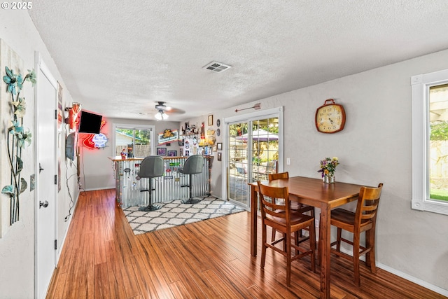 3131 Alyndale Dr, Eugene, OR 97404 - dining space featuring a textured ceiling, ceiling fan, wood finished floors, and baseboards