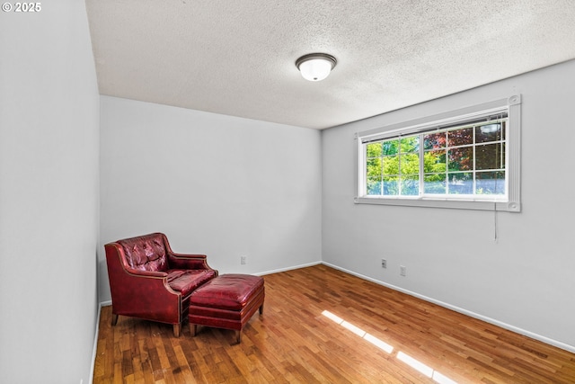3131 Alyndale Dr, Eugene, OR 97404 - living area featuring wood finished floors, a textured ceiling, and baseboards
