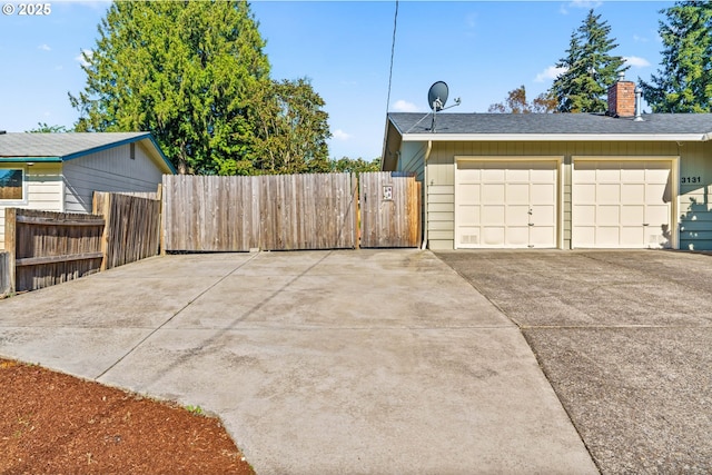 3131 Alyndale Dr, Eugene, OR 97404 - view of home's exterior featuring fence, a chimney, a garage, driveway, and a shingled roof