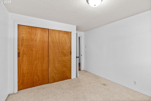 3131 Alyndale Dr, Eugene, OR 97404 - unfurnished bedroom with a closet, carpet flooring, and a textured ceiling