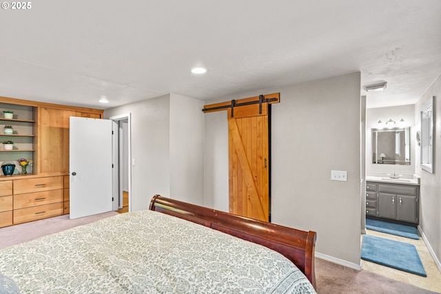 3131 Alyndale Dr, Eugene, OR 97404 - bedroom with light carpet, a sink, a barn door, recessed lighting, and baseboards