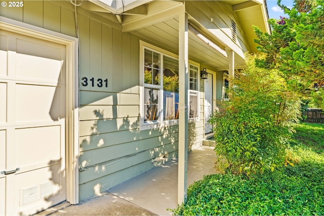 view of exterior entry with covered porch
