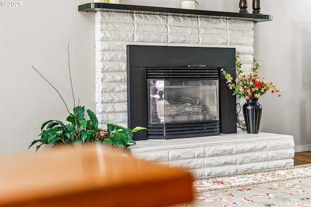 3131 Alyndale Dr, Eugene, OR 97404 - detailed view of a glass covered fireplace, baseboards, and wood finished floors