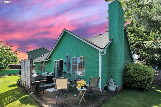 10903 NW 5th Ave, Vancouver, WA 98685 - back of property at dusk featuring a chimney, a shingled roof, a wooden deck, and outdoor dining area