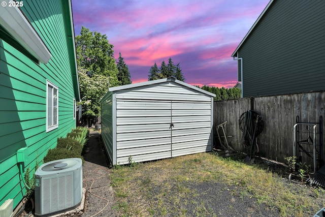 10903 NW 5th Ave, Vancouver, WA 98685 - outdoor structure at dusk with central AC, a storage shed, and a fenced backyard