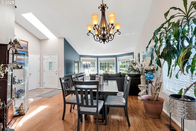10903 NW 5th Ave, Vancouver, WA 98685 - dining space with wood finished floors, a chandelier, baseboards, and high vaulted ceiling