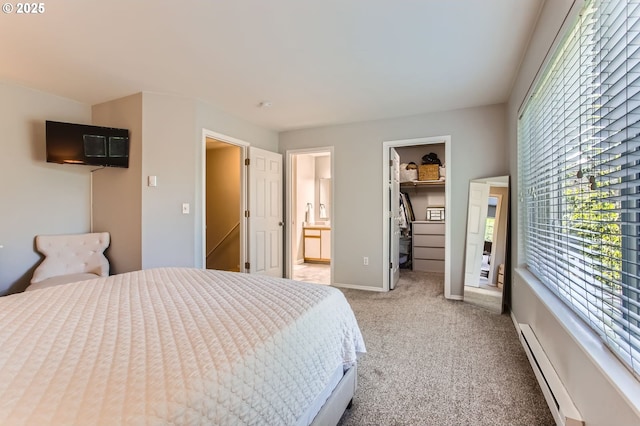 7151 SW Sagert St Unit 101, Tualatin, OR 97062 - bedroom with baseboard heating, light colored carpet, a spacious closet, connected bathroom, and a closet