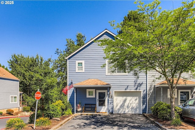 7151 SW Sagert St Unit 101, Tualatin, OR 97062 - view of front of house featuring asphalt driveway and an attached garage