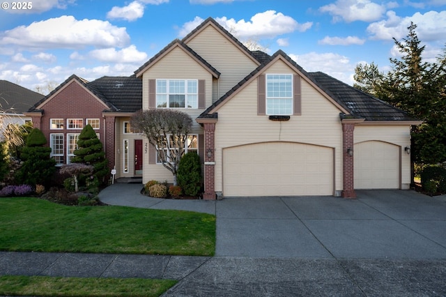 traditional-style home featuring concrete driveway, brick siding, a front lawn, and an attached garage