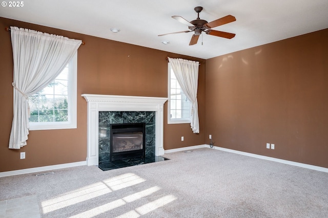 unfurnished living room featuring a fireplace, carpet flooring, and baseboards