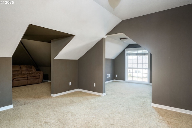 bonus room with lofted ceiling, carpet flooring, and baseboards