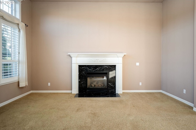 interior details with a premium fireplace, carpet, and baseboards