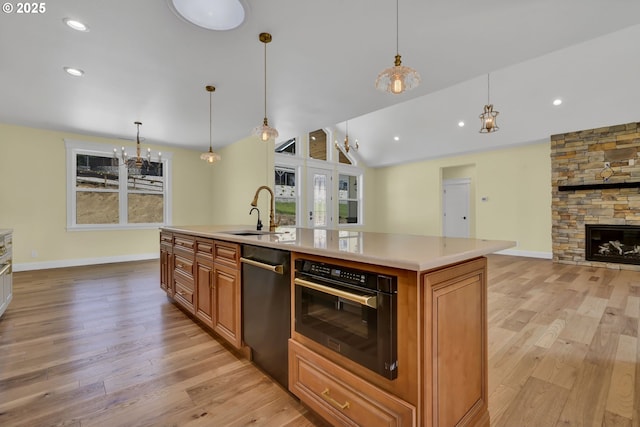83594 Sauter Dr, Florence, OR 97439 - kitchen with a sink, dishwasher, light wood-type flooring, light countertops, and open floor plan
