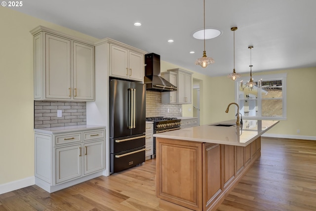 83594 Sauter Dr, Florence, OR 97439 - kitchen featuring wall chimney range hood, high quality appliances, a sink, light wood-style flooring, and recessed lighting