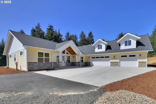 83594 Sauter Dr, Florence, OR 97439 - view of front of property with stone siding, concrete driveway, a garage, and a shingled roof