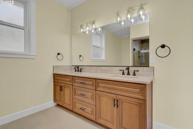 83594 Sauter Dr, Florence, OR 97439 - bathroom featuring baseboards, double vanity, and tasteful backsplash