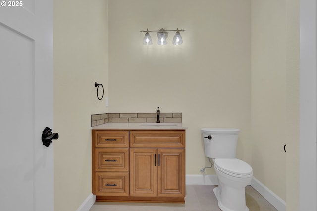 83594 Sauter Dr, Florence, OR 97439 - half bath featuring a sink, toilet, baseboards, and tile patterned floors