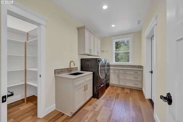 83594 Sauter Dr, Florence, OR 97439 - washroom with cabinet space, washer and clothes dryer, light wood-type flooring, recessed lighting, and baseboards