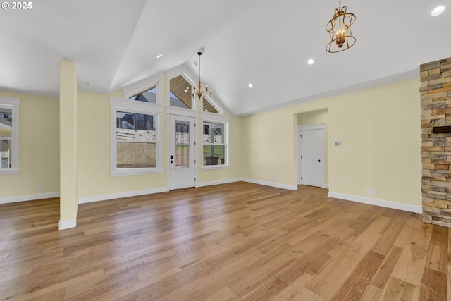 83594 Sauter Dr, Florence, OR 97439 - unfurnished living room featuring a chandelier, lofted ceiling, light wood-style flooring, baseboards, and recessed lighting