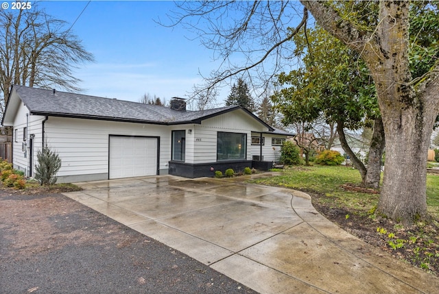 single story home with an attached garage, brick siding, concrete driveway, roof with shingles, and a chimney