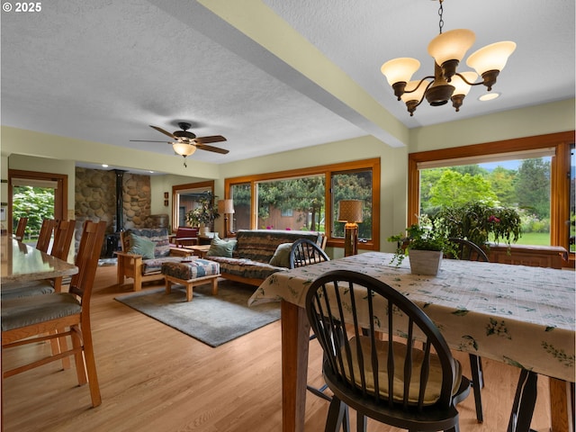 24880 E Arrah Wanna Blvd, Welches, OR 97067 - dining space with a textured ceiling, healthy amount of natural light, a chandelier, light wood finished floors, and ceiling fan