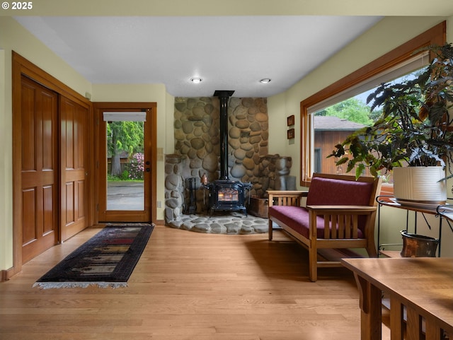 24880 E Arrah Wanna Blvd, Welches, OR 97067 - foyer entrance with a wood stove and wood finished floors