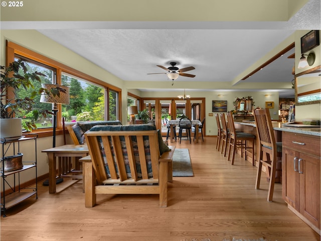 24880 E Arrah Wanna Blvd, Welches, OR 97067 - living room with a ceiling fan, light wood finished floors, and healthy amount of natural light