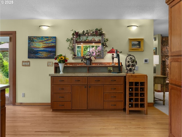 24880 E Arrah Wanna Blvd, Welches, OR 97067 - bar featuring light wood-type flooring, a textured ceiling, and baseboards