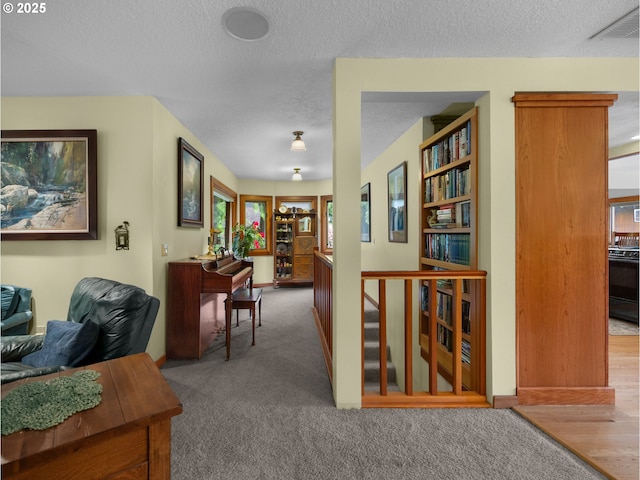 24880 E Arrah Wanna Blvd, Welches, OR 97067 - hallway with a textured ceiling, an upstairs landing, and carpet floors