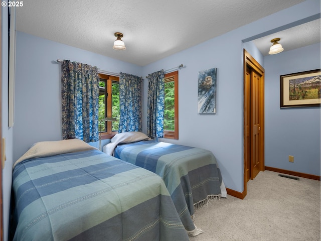 24880 E Arrah Wanna Blvd, Welches, OR 97067 - bedroom featuring baseboards, carpet flooring, a textured ceiling, and a closet