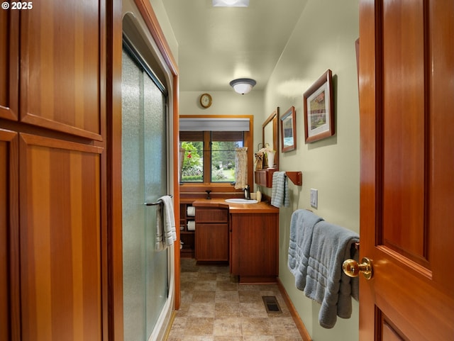 24880 E Arrah Wanna Blvd, Welches, OR 97067 - bathroom with a stall shower, vanity, and stone finish floors