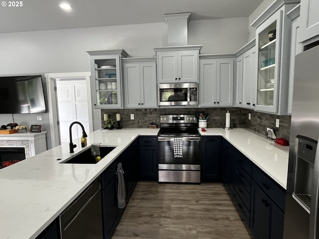 78115 Giger Ln, Weston, OR 97886 - kitchen with stainless steel appliances, a sink, tasteful backsplash, dark wood finished floors, and light stone counters