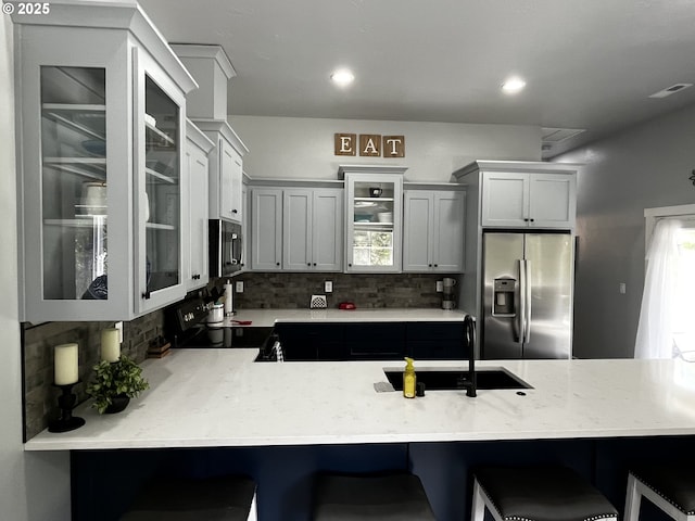 78115 Giger Ln, Weston, OR 97886 - kitchen featuring stainless steel appliances, a sink, tasteful backsplash, glass insert cabinets, and recessed lighting