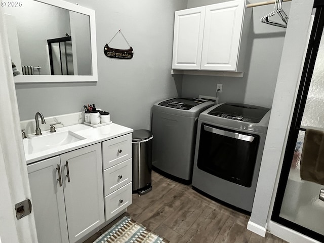 78115 Giger Ln, Weston, OR 97886 - laundry room featuring cabinet space, washing machine and clothes dryer, and dark wood-style floors