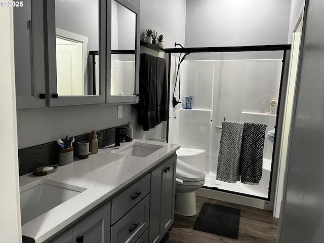 78115 Giger Ln, Weston, OR 97886 - full bath featuring toilet, a stall shower, wood finished floors, and double vanity