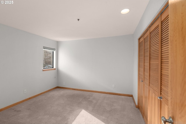 unfurnished bedroom featuring carpet and a closet