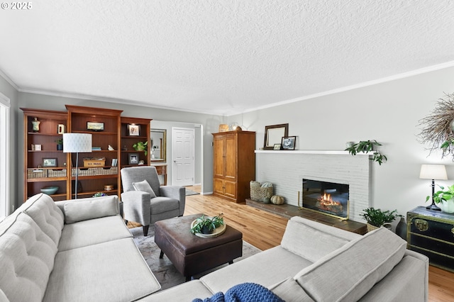 819 SE 98th Ave, Vancouver, WA 98664 - living area featuring light wood-type flooring, ornamental molding, a textured ceiling, and a fireplace