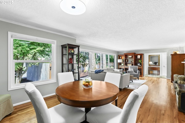 819 SE 98th Ave, Vancouver, WA 98664 - dining area featuring plenty of natural light, a textured ceiling, light wood finished floors, and crown molding