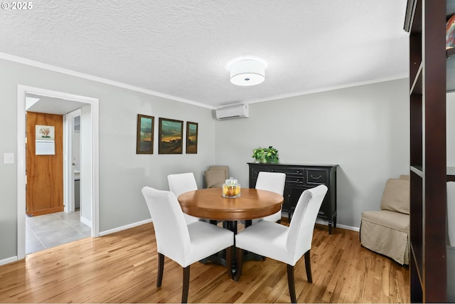 819 SE 98th Ave, Vancouver, WA 98664 - dining area with light wood-type flooring, a wall mounted air conditioner, ornamental molding, and a textured ceiling