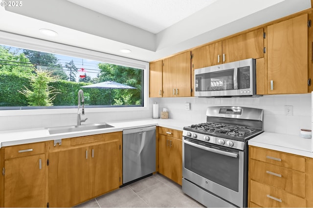 819 SE 98th Ave, Vancouver, WA 98664 - kitchen featuring stainless steel appliances, light countertops, decorative backsplash, and light tile patterned floors